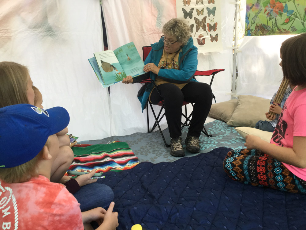 reading a book to children at monarch festival